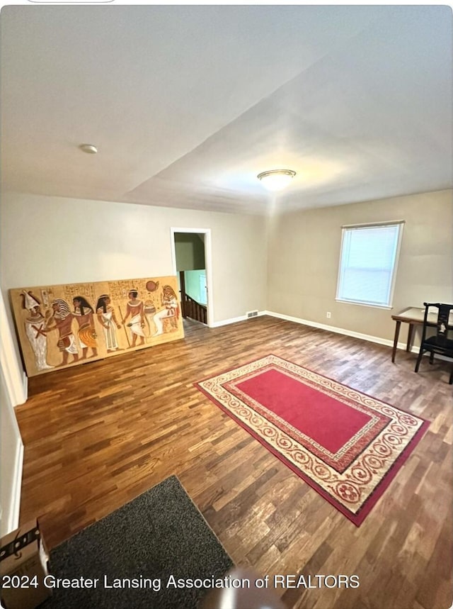 sitting room with visible vents, baseboards, and wood finished floors