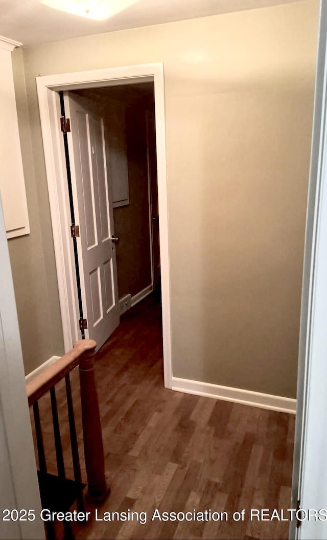 hallway with baseboards and wood finished floors