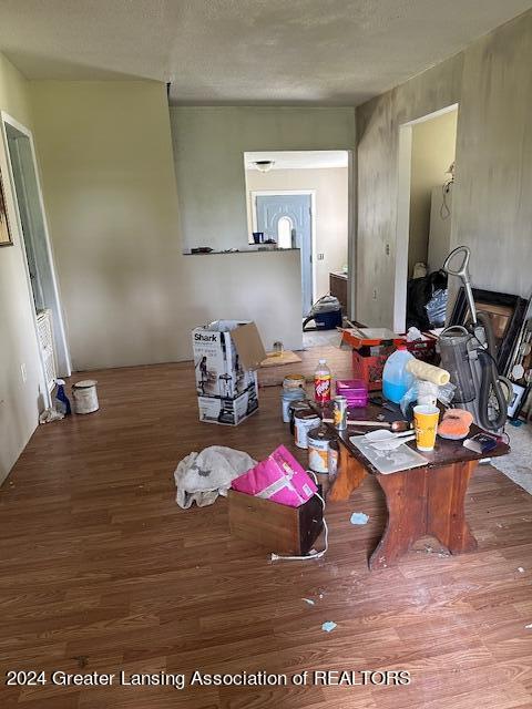 misc room featuring hardwood / wood-style floors and a textured ceiling