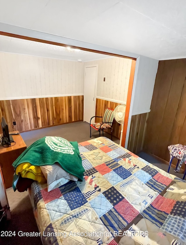 bedroom with wood walls