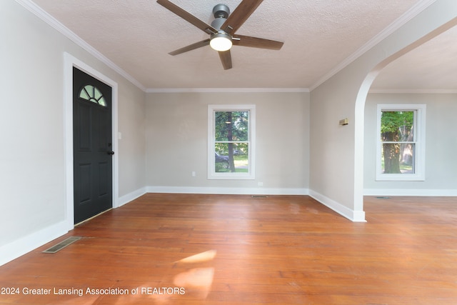 foyer entrance with crown molding, ceiling fan, a textured ceiling, and light hardwood / wood-style flooring