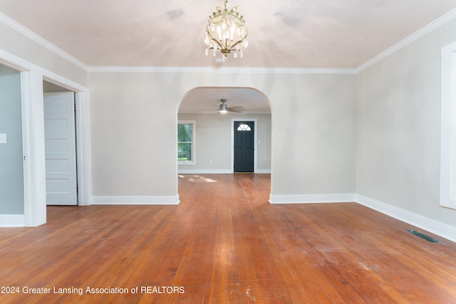 unfurnished room featuring crown molding, ceiling fan with notable chandelier, hardwood / wood-style floors, and a textured ceiling