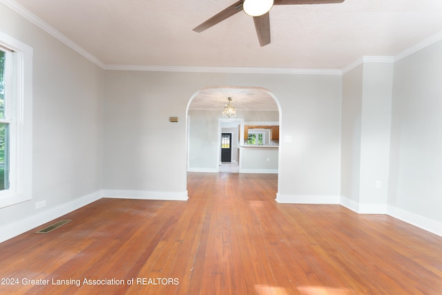 unfurnished room with ceiling fan, ornamental molding, hardwood / wood-style floors, and a textured ceiling