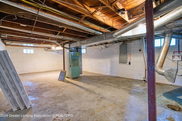 basement with heating unit and electric panel