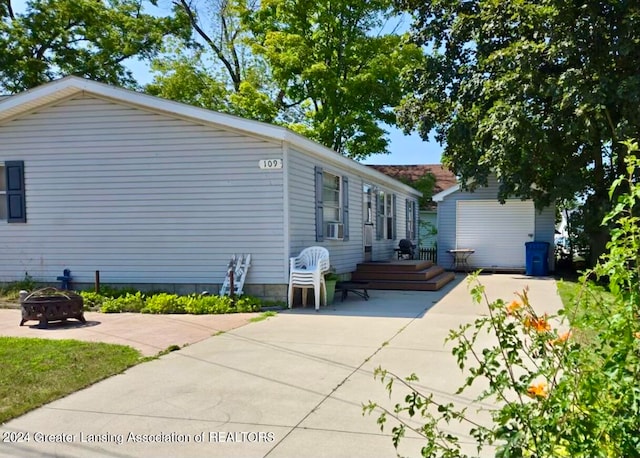 view of front of property with a fire pit and a patio