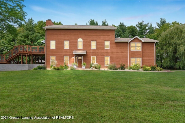 view of front facade with a front yard and a deck