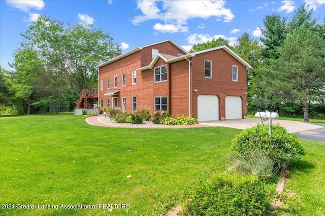 view of front of property with a garage, a front lawn, and a deck