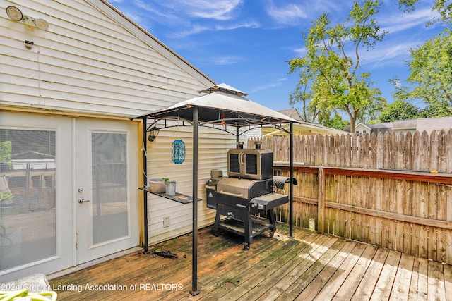 wooden terrace featuring french doors and a gazebo