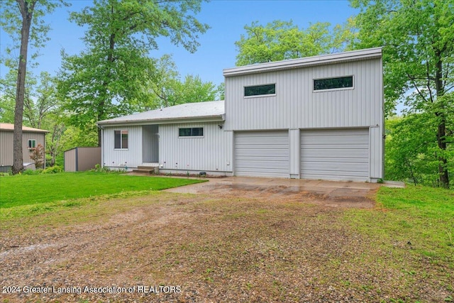 view of front of home with a garage and a front lawn