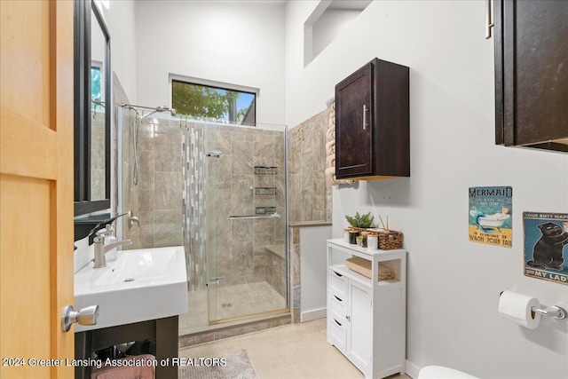 bathroom with a shower with door and vanity