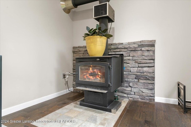 interior details featuring hardwood / wood-style flooring and a wood stove