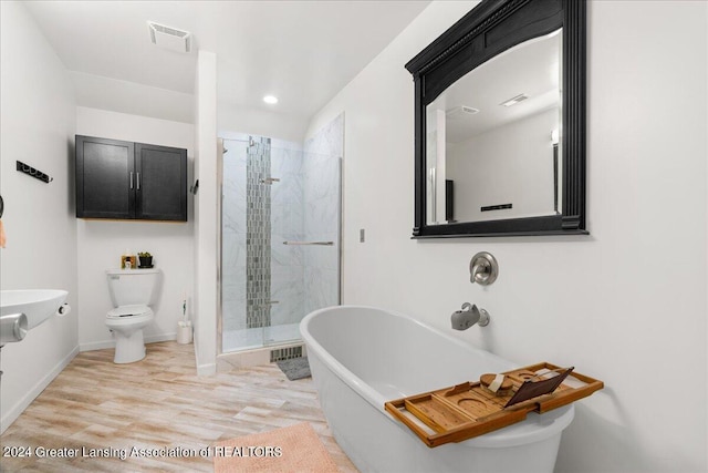 bathroom featuring wood-type flooring, separate shower and tub, and toilet