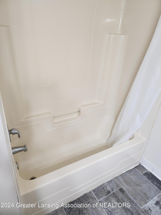 bathroom featuring bathing tub / shower combination and tile patterned floors