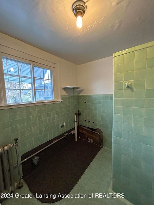 bathroom with tile walls and radiator heating unit