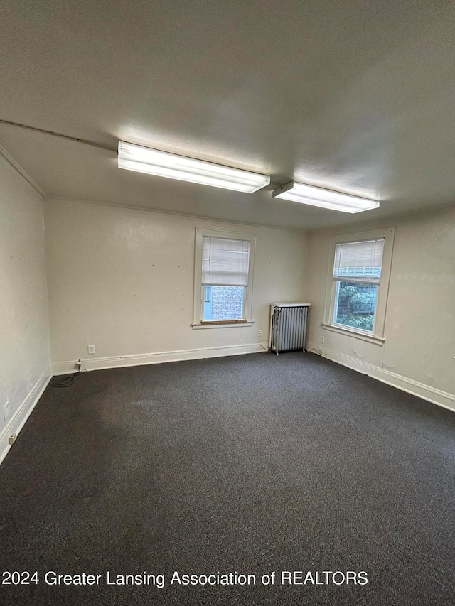 carpeted spare room with radiator