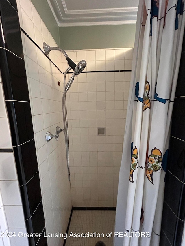 bathroom featuring crown molding and a shower with shower curtain