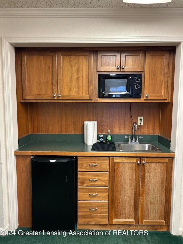 kitchen with sink and fridge