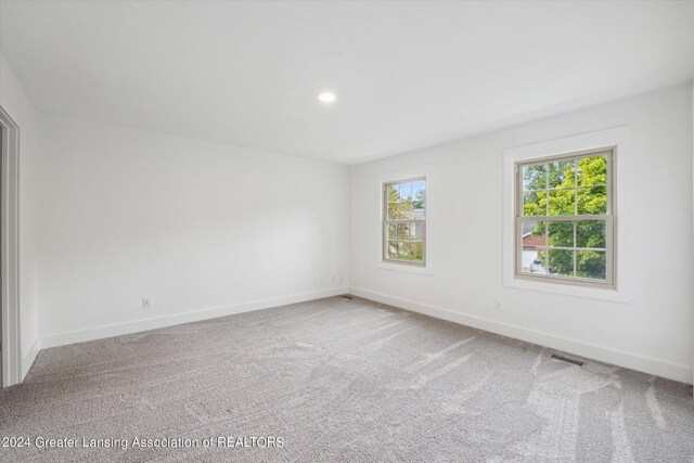 spare room with light colored carpet