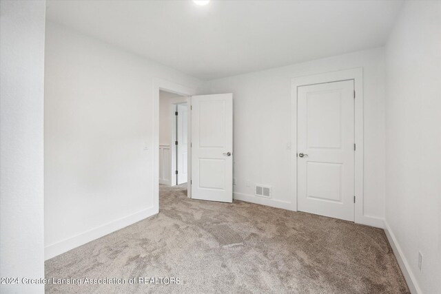 unfurnished bedroom with light carpet