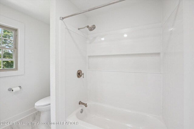 bathroom featuring toilet and shower / bathing tub combination