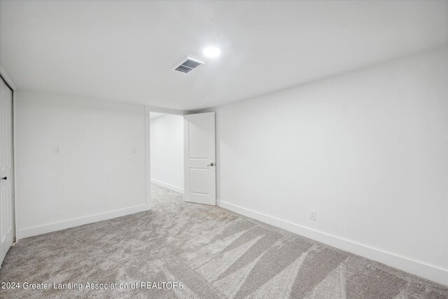 unfurnished bedroom with light colored carpet