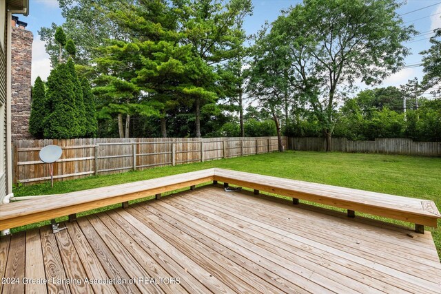 wooden terrace with a lawn