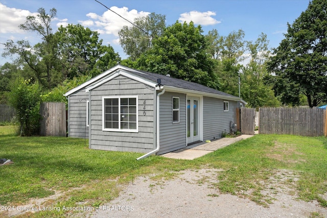 view of outbuilding featuring fence