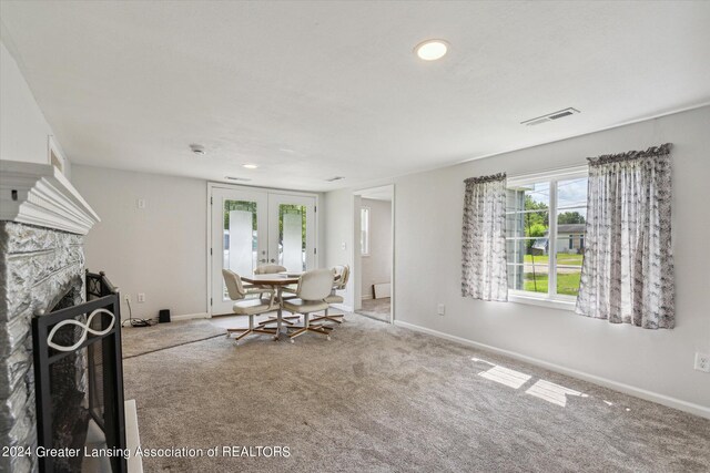 unfurnished dining area with carpet flooring and french doors