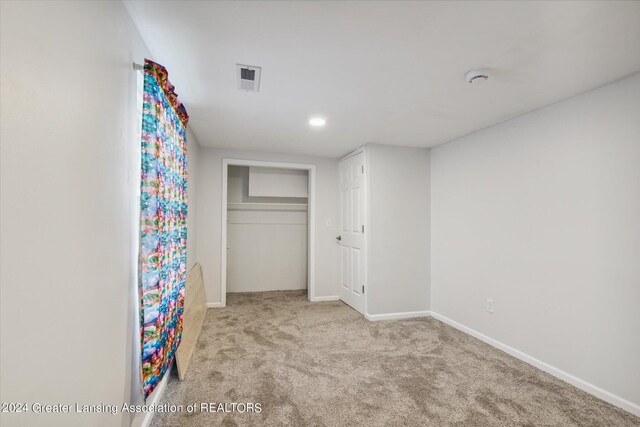 unfurnished bedroom featuring light carpet