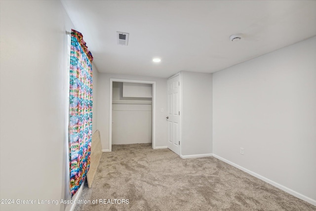 unfurnished bedroom featuring carpet, a closet, visible vents, and baseboards