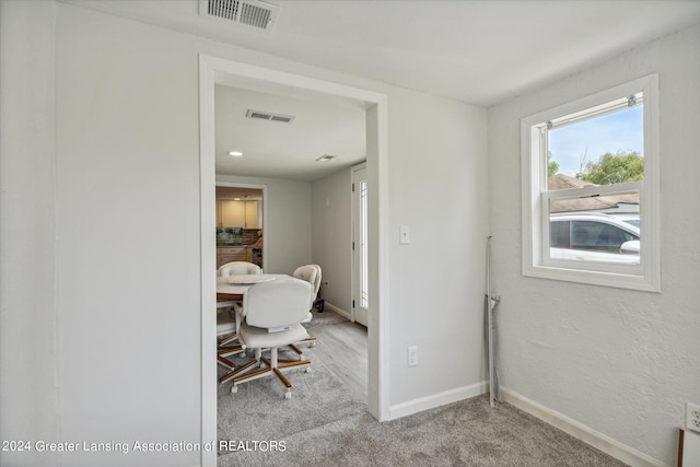 carpeted office space featuring visible vents and baseboards