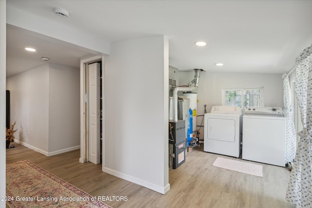 washroom with laundry area, baseboards, light wood-type flooring, washing machine and dryer, and recessed lighting