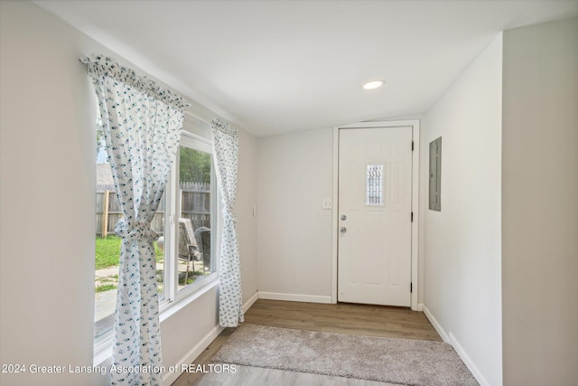 foyer with recessed lighting, wood finished floors, electric panel, and baseboards