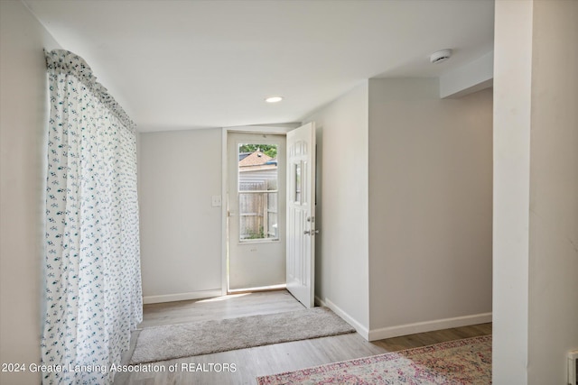 foyer featuring recessed lighting, baseboards, and wood finished floors