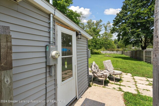 exterior space with a patio area and a lawn