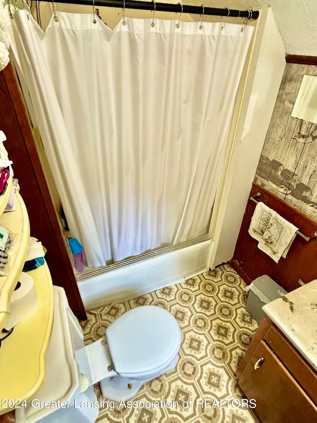 bathroom featuring walk in shower, toilet, and vanity