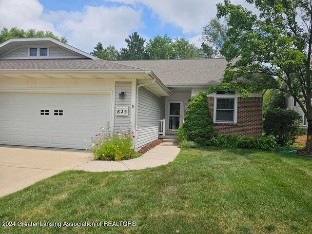 view of front facade featuring a garage and a front lawn