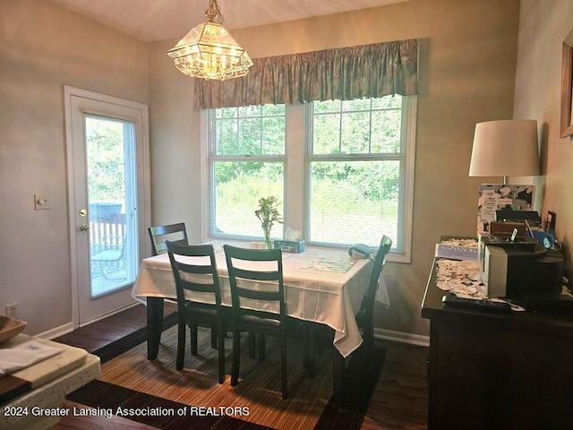 dining area featuring dark hardwood / wood-style flooring and a notable chandelier