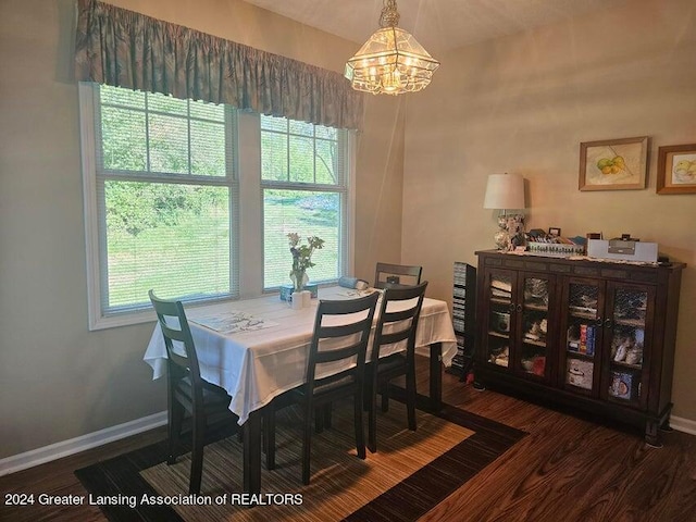 dining space with an inviting chandelier, hardwood / wood-style flooring, and a wealth of natural light