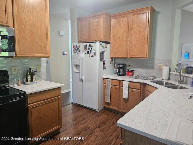 kitchen with sink, backsplash, black electric range oven, dark hardwood / wood-style floors, and white refrigerator with ice dispenser