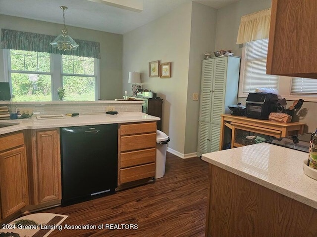 kitchen featuring black dishwasher, decorative backsplash, dark hardwood / wood-style floors, and hanging light fixtures