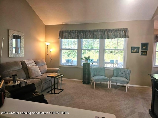 living room with lofted ceiling, carpet floors, and a wealth of natural light