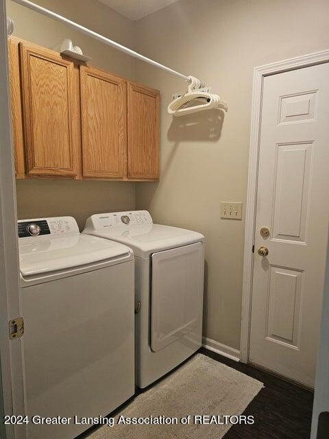 laundry room featuring washing machine and dryer and cabinets