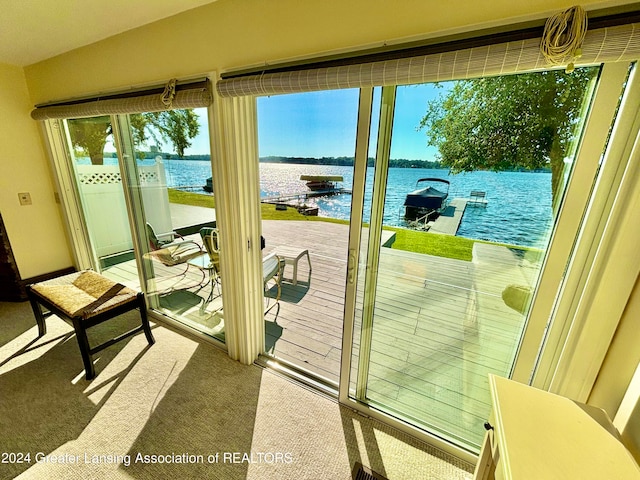 doorway featuring a water view and carpet floors