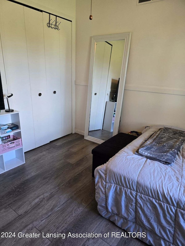 bedroom with dark hardwood / wood-style flooring