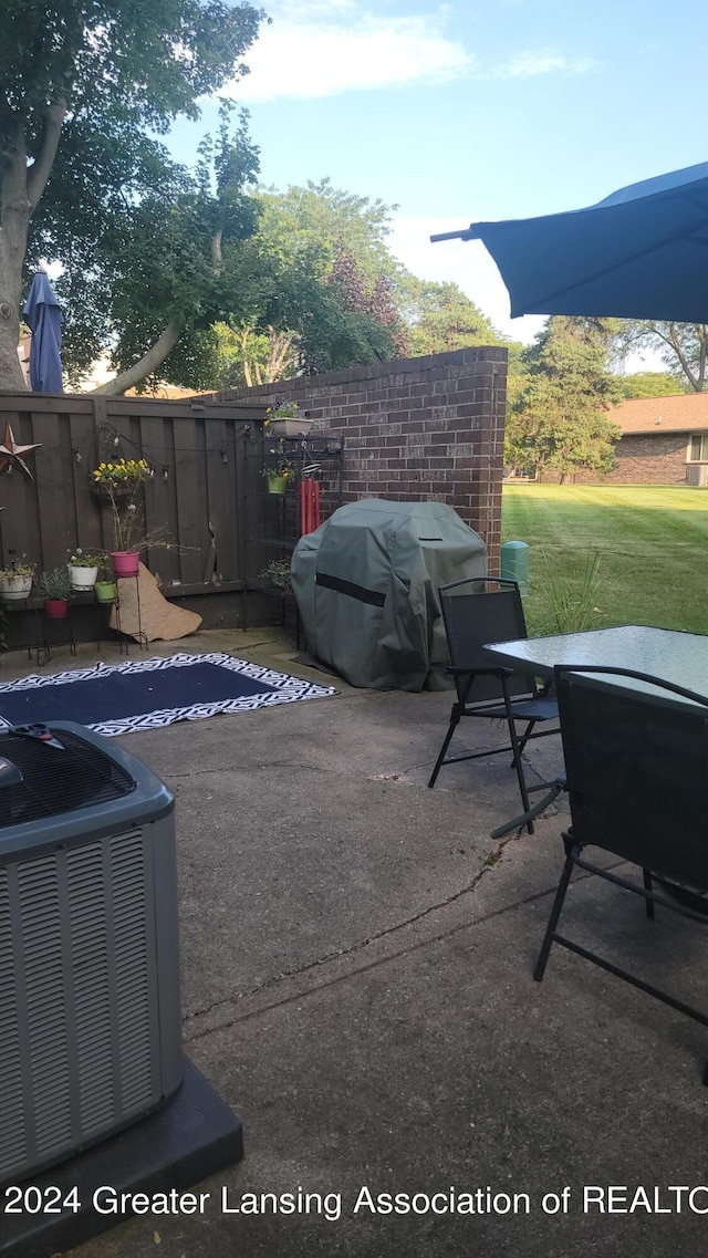 view of patio / terrace with grilling area and central air condition unit