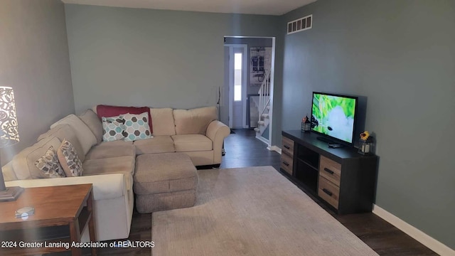 living room featuring dark wood-type flooring