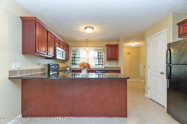 kitchen featuring black appliances, a textured ceiling, dark stone counters, kitchen peninsula, and light tile patterned flooring