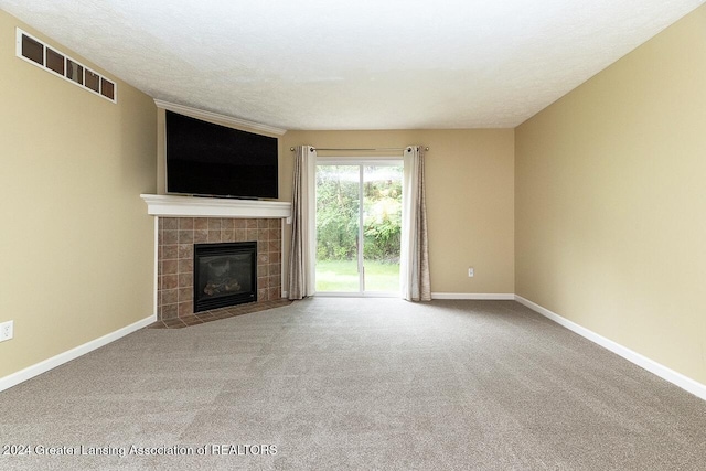 unfurnished living room featuring carpet and a fireplace