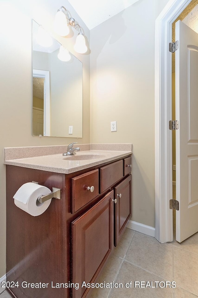 bathroom with tile patterned floors and vanity